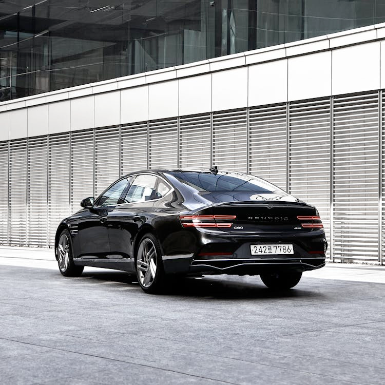 A modern sedan parked in a clean urban environment