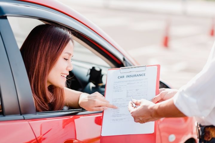 Happy driver reviewing car insurance policy options